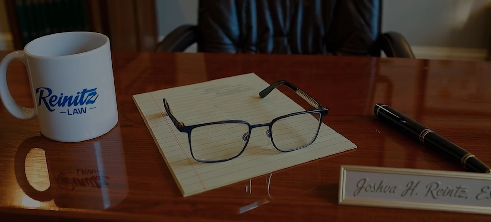 Attorney Josh Reinitz defense attorney's desk with a pen and paper ready
